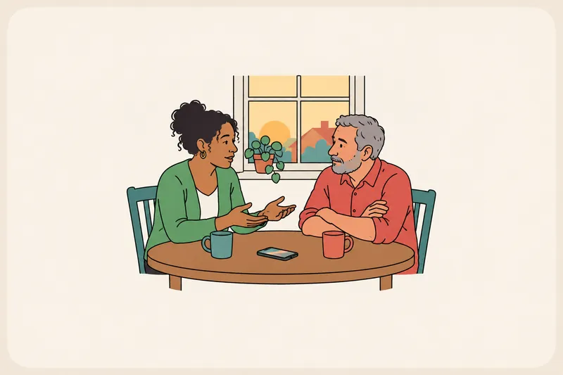 Two people at a kitchen table; one speaks calmly with open hands while the other listens with folded arms.