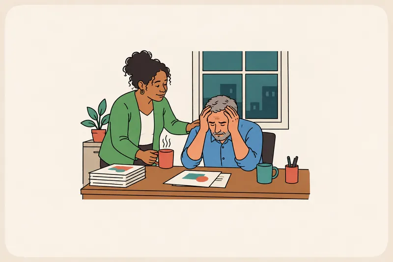 A tense colleague sits with head in hands at a late-evening desk while a coworker gently sets down a cup of tea and rests a hand on their shoulder.