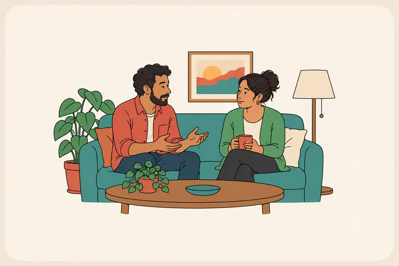 A couple sits on a sofa on a calm afternoon, turned toward each other; one explains something gently while the other listens, holding a mug.